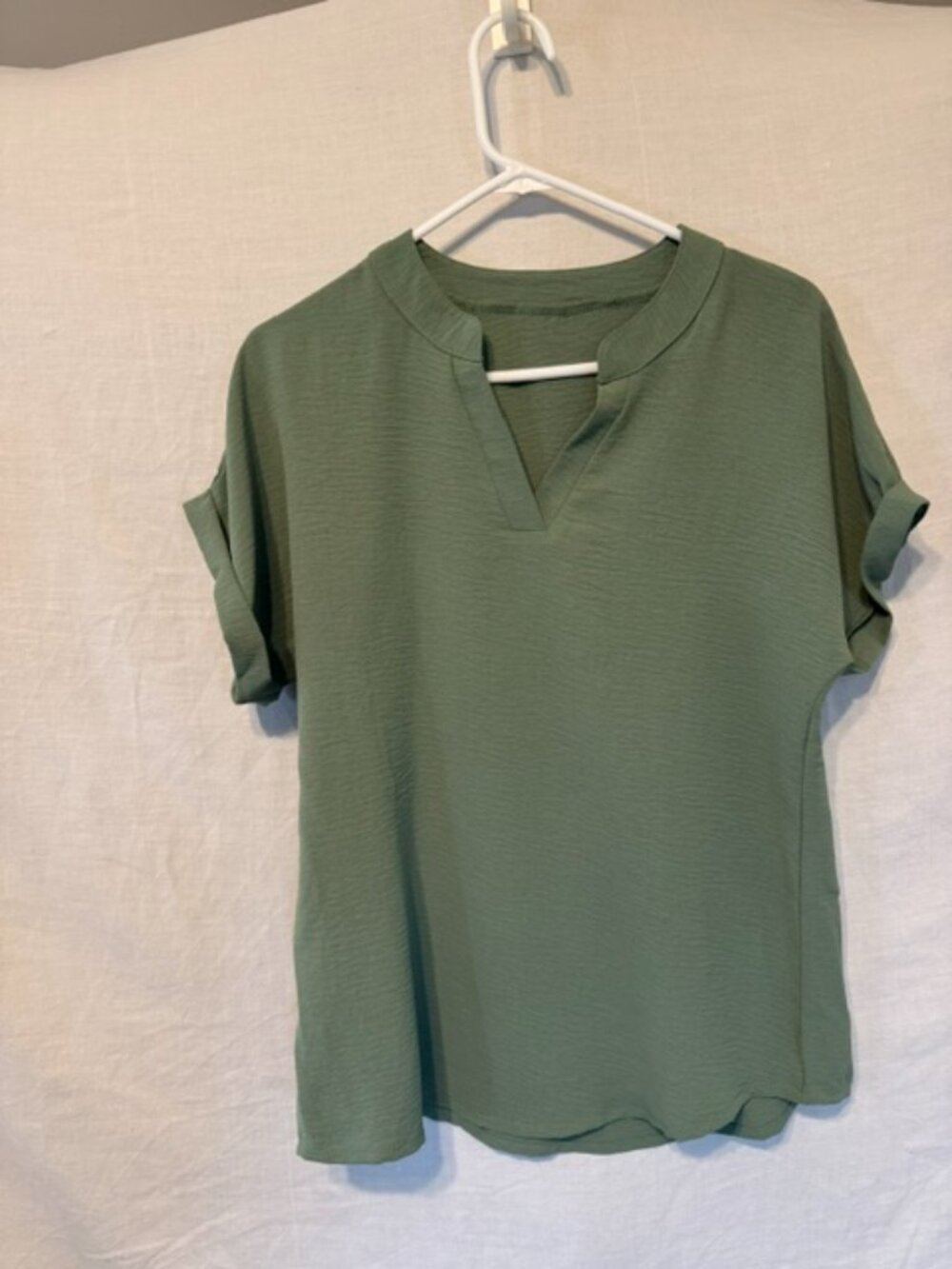 Short sleeved moss green shirt.